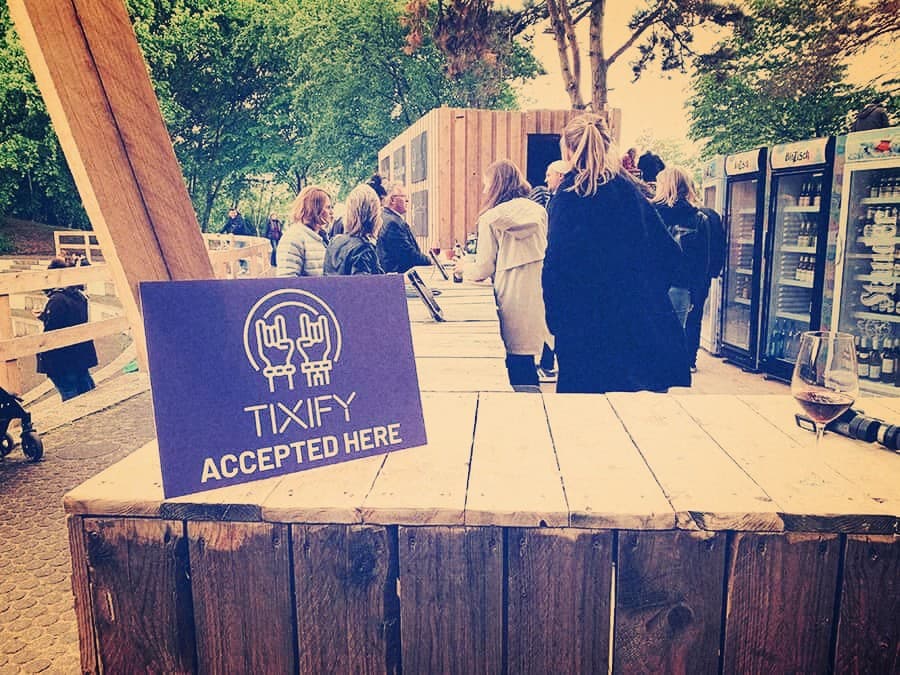 Tixify accepted here sign at a festival bar